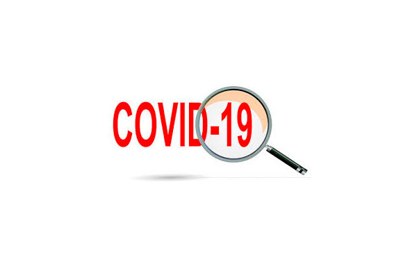 Uma lupa em uma palavra escrita: COVID-19